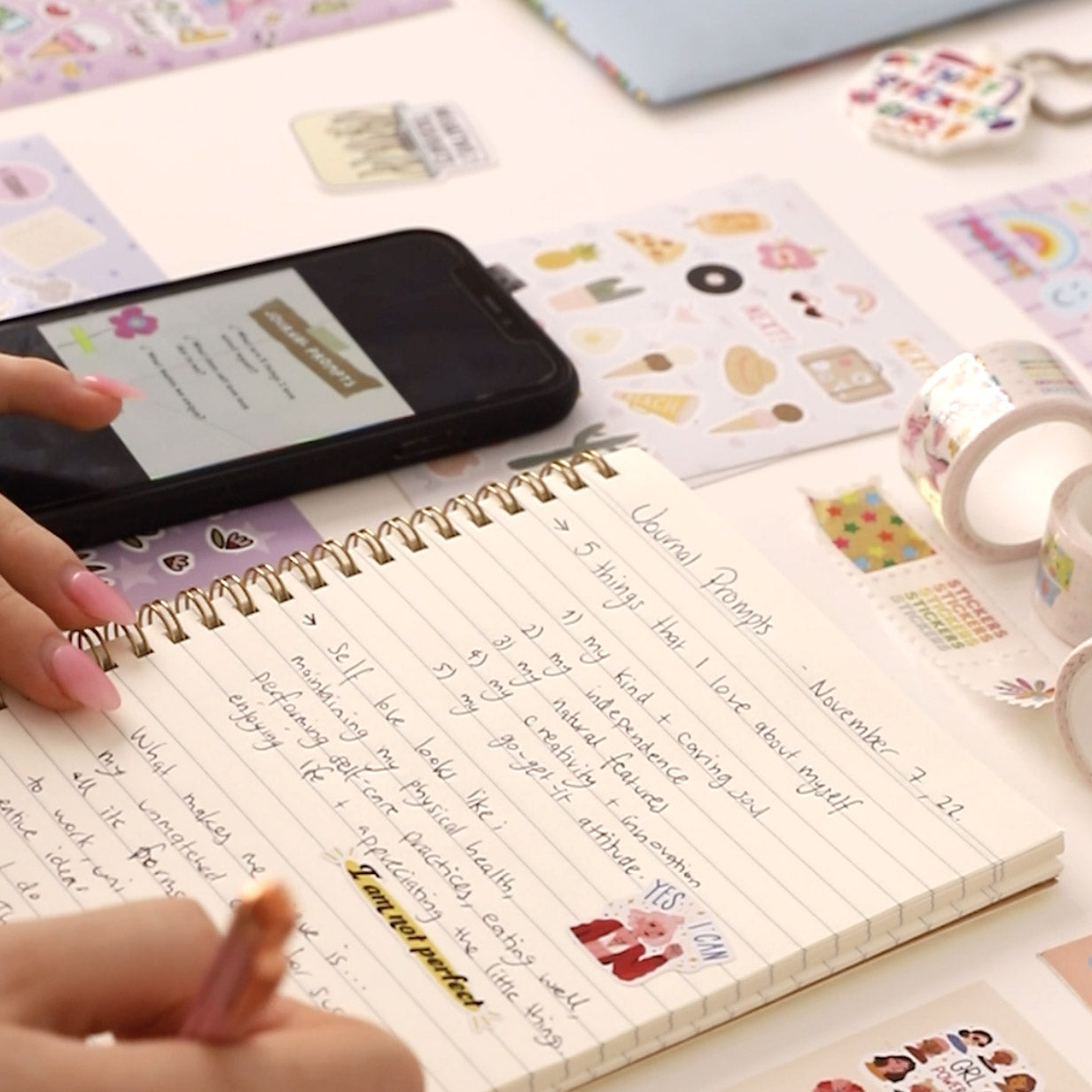 A woman uses Postix stickers in her notebooks with journal prompts