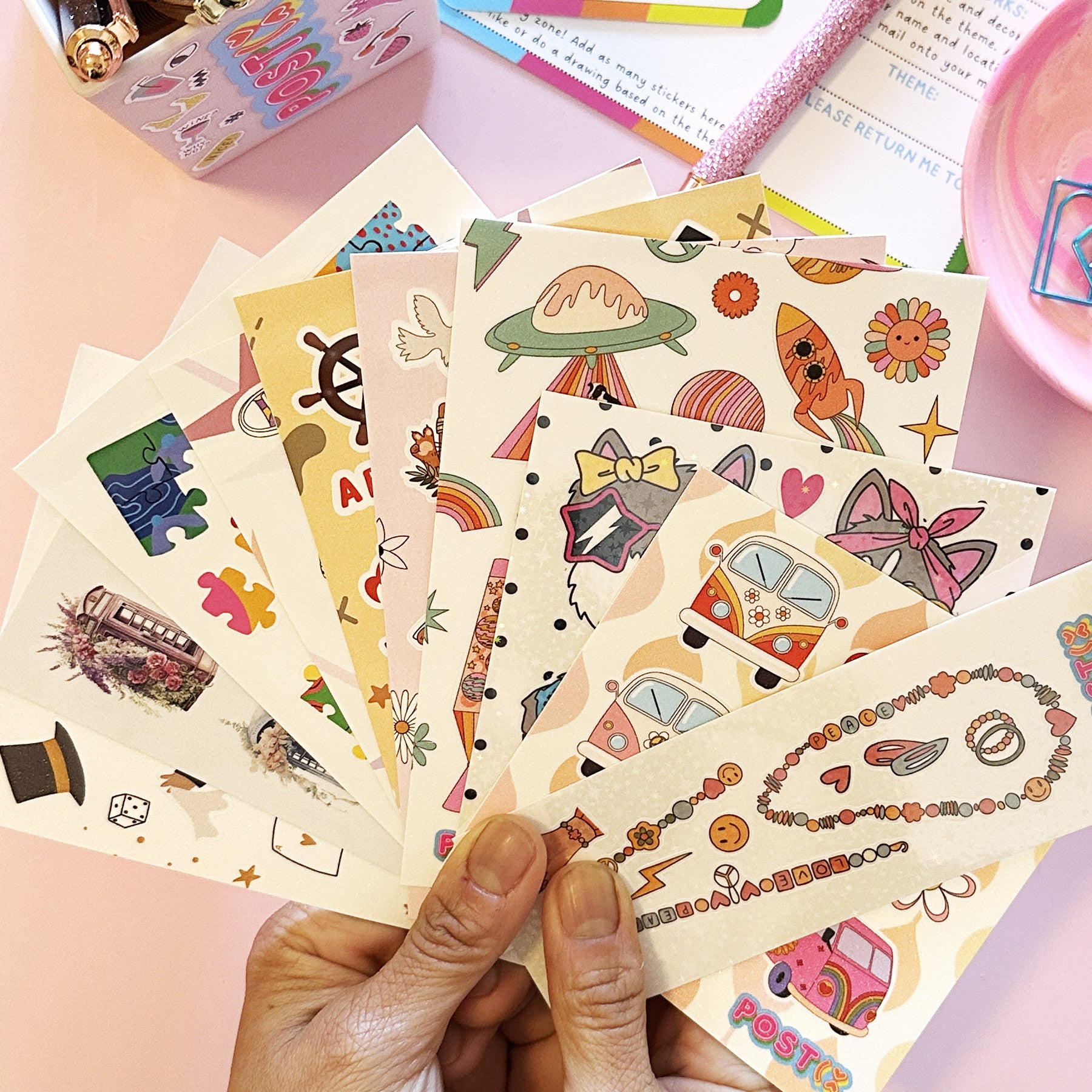 A woman holds a selection of Postix stickers