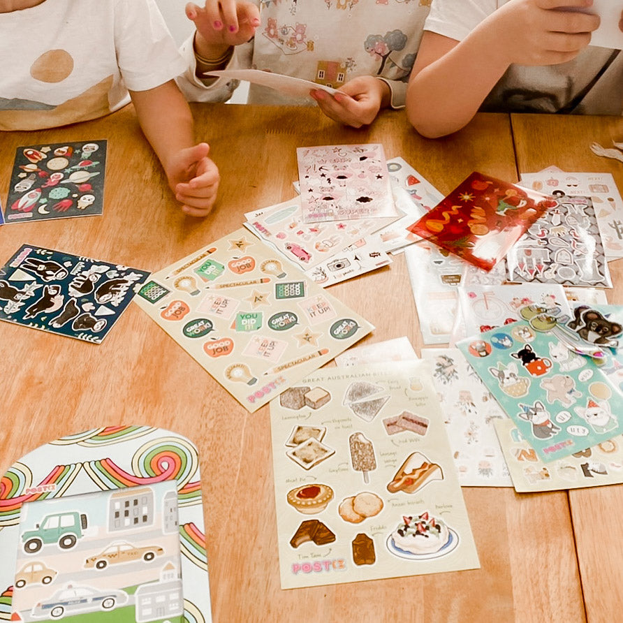 Kids play with a selection of Postix stickers